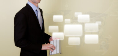 Portrait of young business man using a wireless keyboard for pre